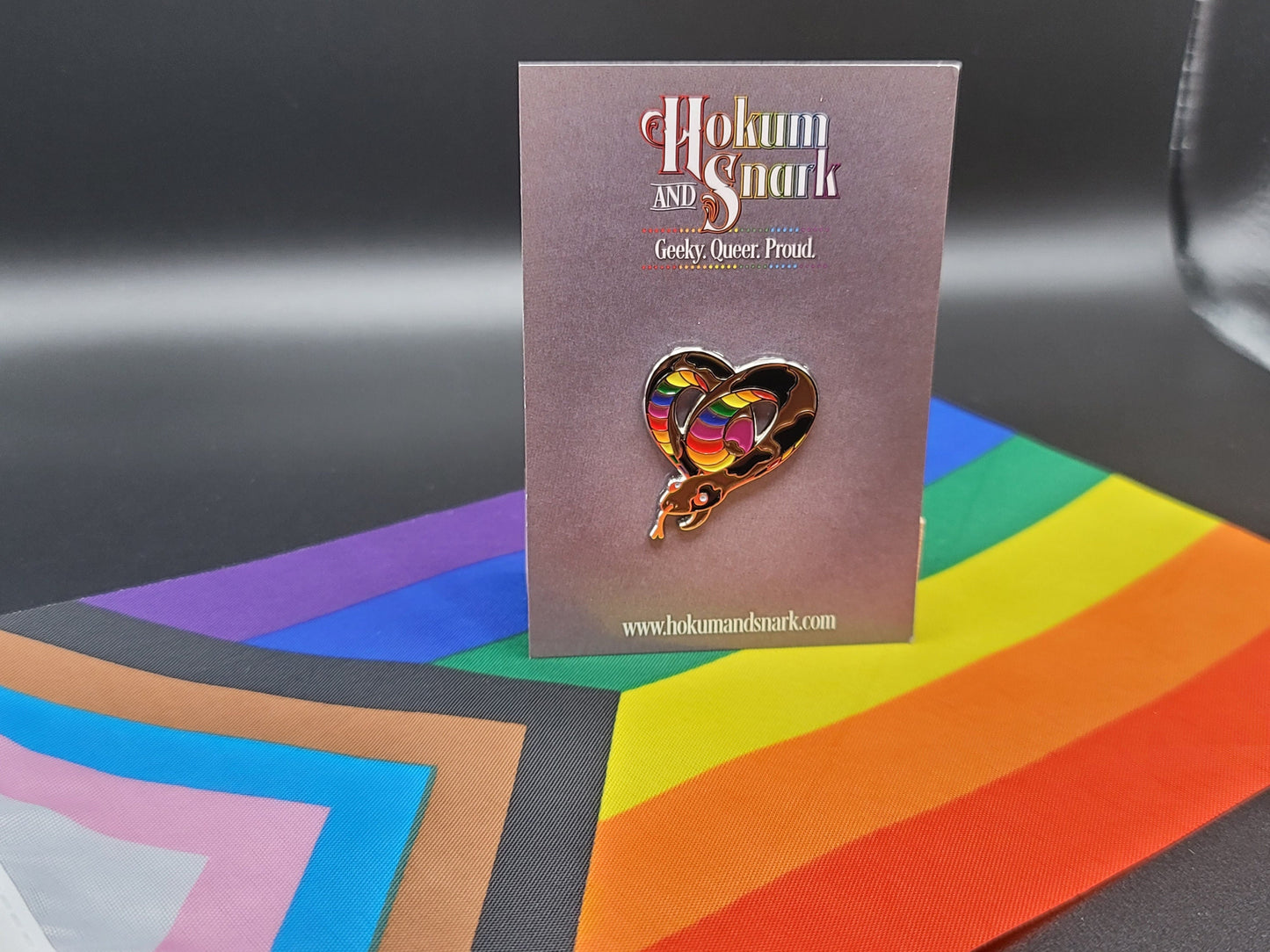 Subtle Pride LGBTQ Rainbow Pride Flag Heart-Shaped Snake Enamel Pin | Brown body, Black Spots, Rainbow Striped Stomach